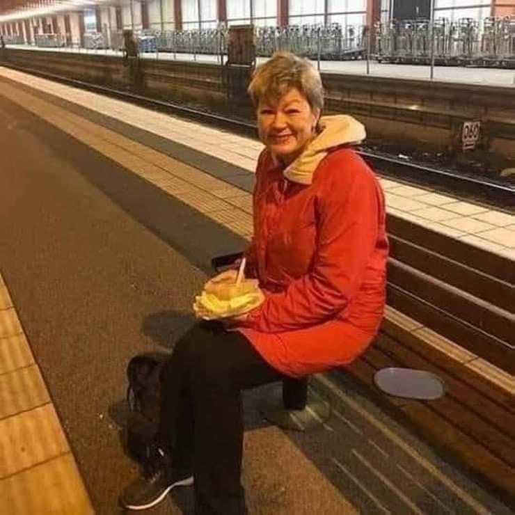 A woman is waiting for a train to return home.