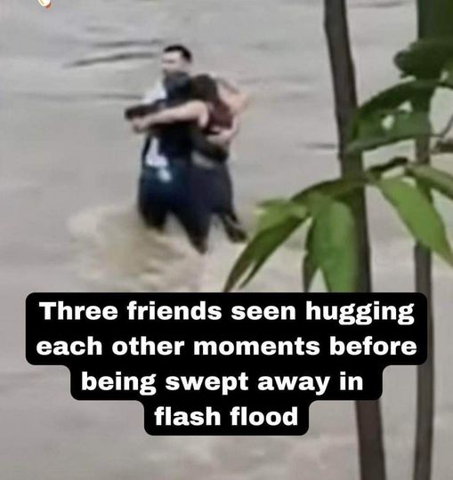 Three friends seen hugging each other moments before being swept away in flash flood